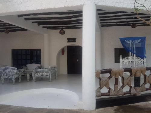 a room with a column and a table and chairs at Scorpio Villas Resort in Malindi