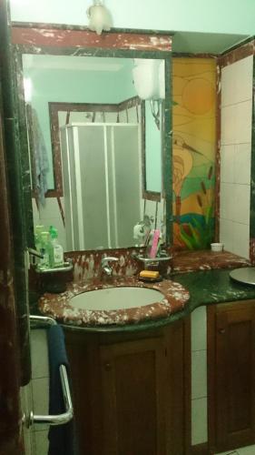 a bathroom with a sink and a mirror at Casa Vacanza Dante in Nurachi