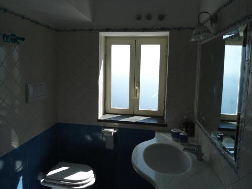 a bathroom with a sink and a window at Le Ghiande in Positano