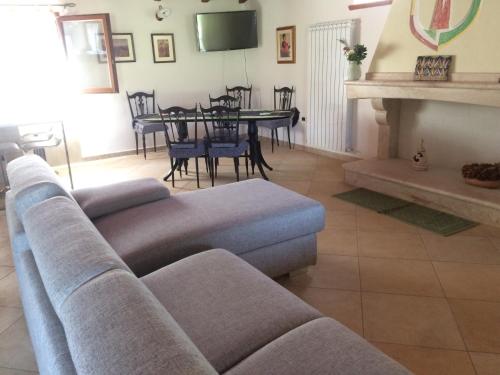 a living room with a couch and a table at S'umbra de S'ozzastru in Orgosolo