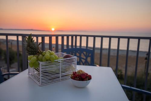 a basket of fruit and a bowl of fruit on a table at Karma Resort in Venetico