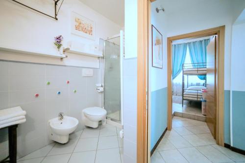 a bathroom with a toilet and a shower and a sink at Casa Bertini in Florence