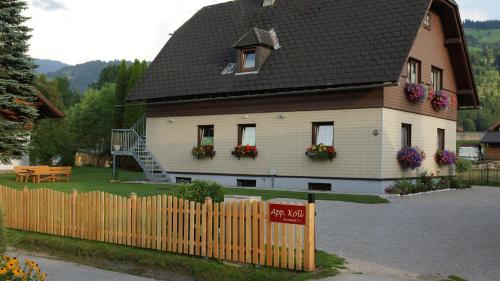 a house with a wooden fence in front of it at Apartment Köll in Aich
