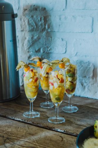 four wine glasses with fruit in them on a table at Sparhof in Dranouter