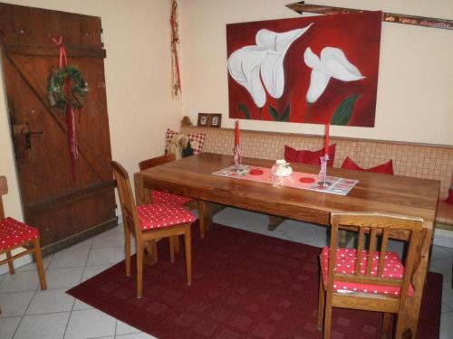 a dining room with a wooden table and chairs at FEWO Jäger in Willingen