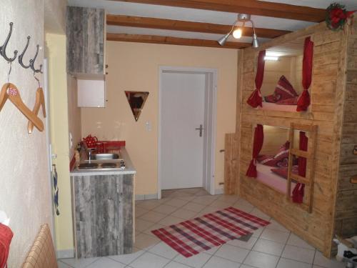 a kitchen with a sink and a room with a bunk bed at FEWO Jäger in Willingen