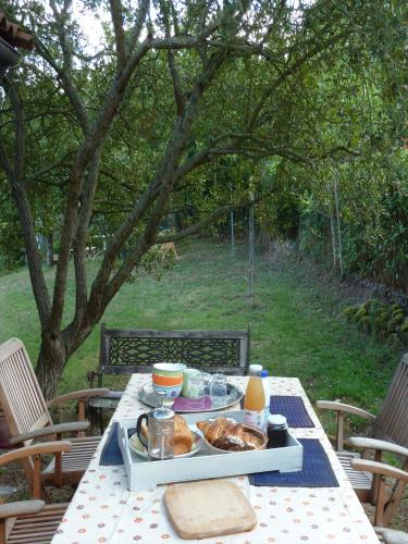 a picnic table with a tray of food on it at maison La Marche in Cugand