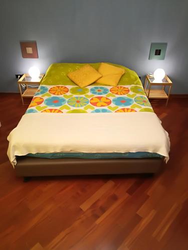 a bed with a colorful blanket on top of it at Casa Maia in Padova