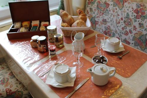 a table with a tea set on top of it at Hôtel de la Meuse in Charleville-Mézières