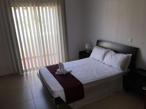 a bedroom with a bed and a large window at Mandria Apartment in Mandria