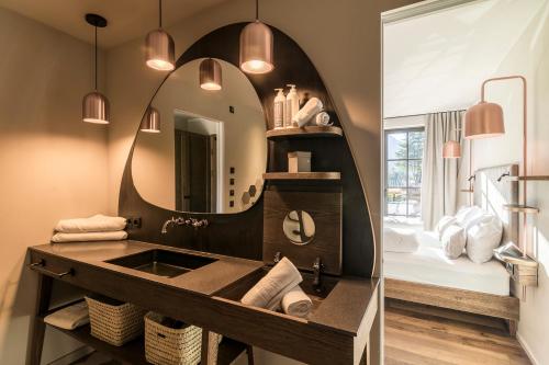a bathroom with a sink and a mirror at Hotel Seehof Nature Retreat in Naz-Sciaves