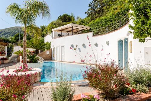 a villa with a swimming pool in a garden at Villa Araucaria in Ischia