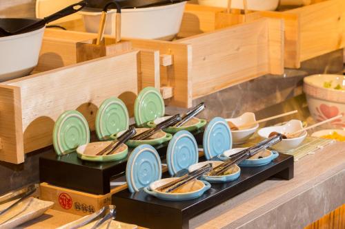 a bunch of plates and chopsticks on a shelf at Hotel East Taipei in Taipei