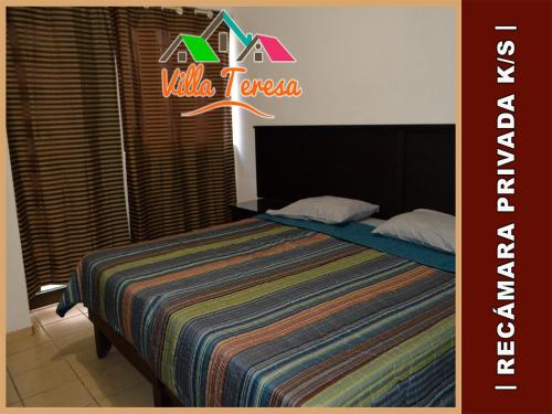 A bed or beds in a room at Departamentos & Suites Villa Teresa