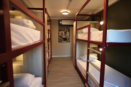 a hallway with three bunk beds in a room at Stay Hybrid Youth Hostel in Thessaloniki