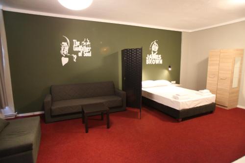 a bedroom with a bed and a couch at Stay Hybrid Youth Hostel in Thessaloniki