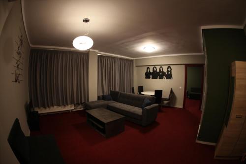 a living room with a couch and a table at Stay Hybrid Youth Hostel in Thessaloniki