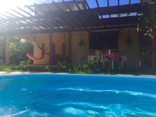 a swimming pool in front of a house at Casa de Férias em Alter do Chão-PA in Alter do Chao