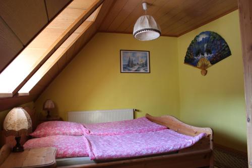a bedroom with a bed with a wooden frame at Ferienwohnung "An der St. Ludmila" in Crostwitz