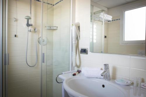 a bathroom with a sink and a shower at Hotel Tropical in Lido di Jesolo