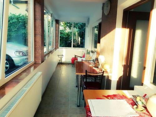 a room with a balcony with a car in the window at Pensiunea Vasilescu in Horezu