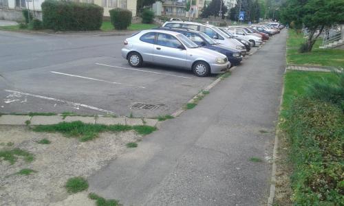 a row of cars parked in a parking lot at Apartman Ortenova 74 in Kutná Hora