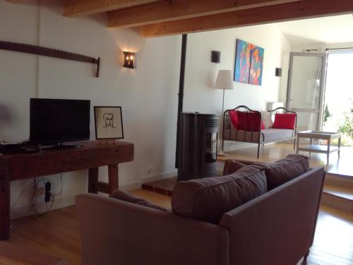 a living room with a couch and a fireplace at Gîte du Besset in Pradelles