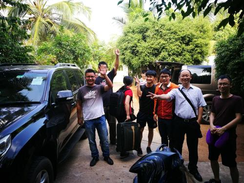 a group of men standing next to a car at Lake Wave Hotel in Anuradhapura