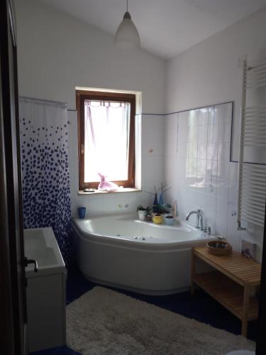 a white bathroom with a tub and a window at Terramadre in Itri