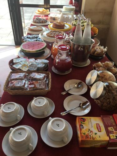 a long table with plates and dishes on it at Masseria Li Campi in Cavallino di Lecce
