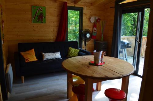 a living room with a table and a couch at Le Village de la Champagne - Slowmoov in Bar-sur-Aube