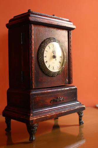 a wooden clock sitting on top of a table at Kira's Boutique Hotel in Mindelo