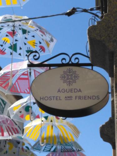 a sign for a hospital and friends with umbrellas at Águeda Hostel & Friends in Águeda