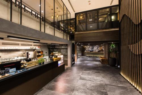 a lobby of a restaurant with a bar at Hotel East Taipei in Taipei