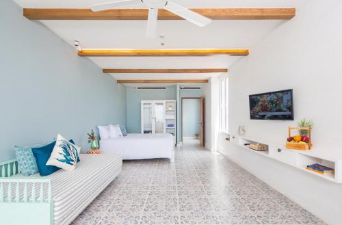 a living room with a bed and a couch at Kept Bangsaray Hotel Pattaya in Bang Sare