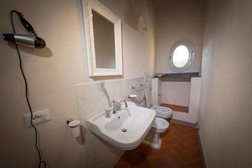 a bathroom with a sink and a toilet at Relais Villa Poschi in Pugnano