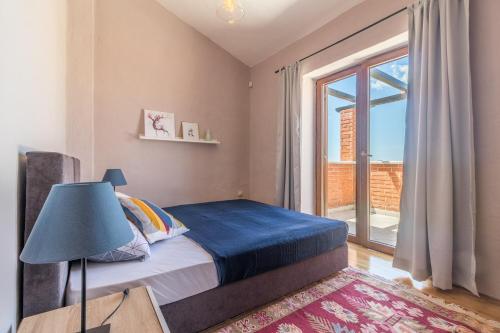 a bedroom with a bed and a large window at Villa Ingrid in Poreč