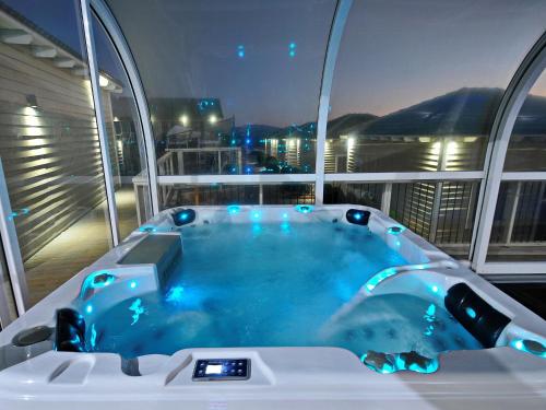a jacuzzi tub on a cruise ship at night at White Suites in Majdal Shams
