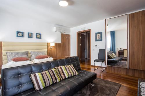 a living room with a couch and a bedroom at Residence Villa Karda in Poreč