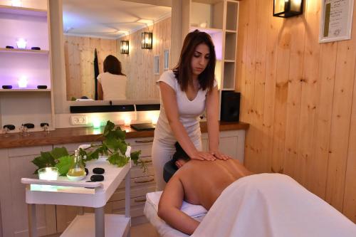 a woman sitting on a chair in a massage room at White Suites in Majdal Shams