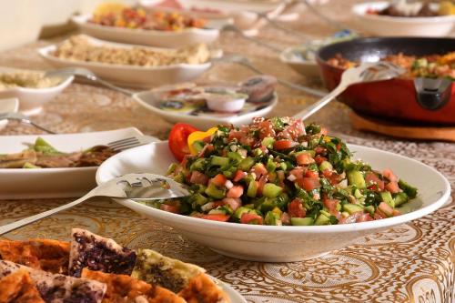 a table with a bowl of food on a table at White Suites in Majdal Shams
