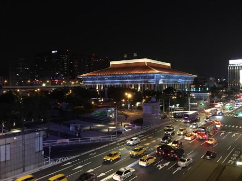a busy city street with traffic at night at Click Hotel - Taipei Main Station Branch in Taipei