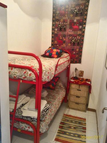 a small room with a bunk bed and a table at Super terrazzo panoramico in Letojanni