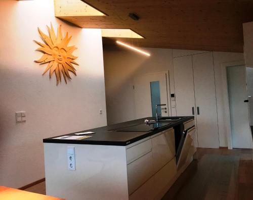a kitchen with a black counter top and a sink at "sunnseit" Appartement in Söll