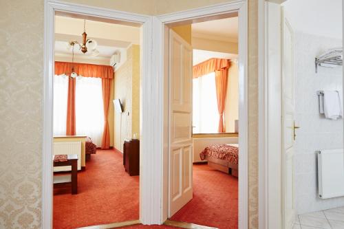 a hotel room with a door leading to a bedroom at Hotel Astoria in Balatonfüred