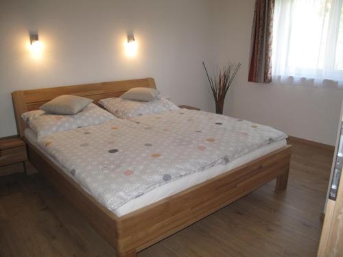 a bedroom with a bed with a wooden frame at Appartement Waldblick in Leogang
