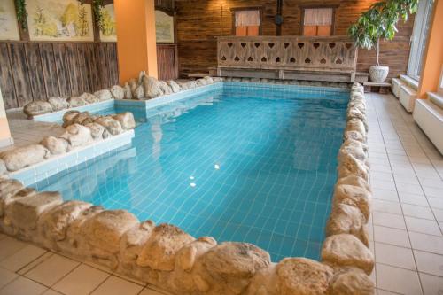 a large swimming pool with a spa in a house at Appartment Krassnig in Turracher Hohe