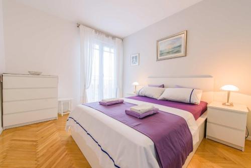 a bedroom with a large bed with two towels on it at Comfortable and Stylish Apartment in Split