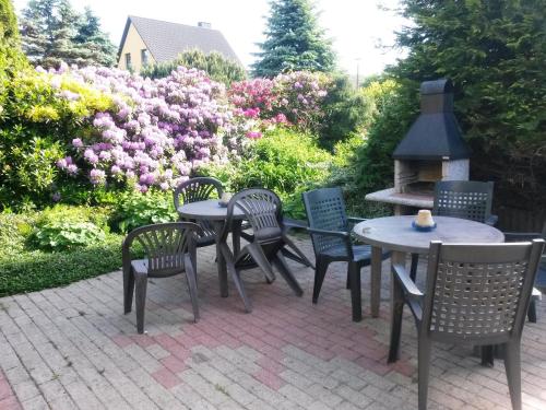 a group of tables and chairs and a fire place at Appartement auf Rügen in Sagard
