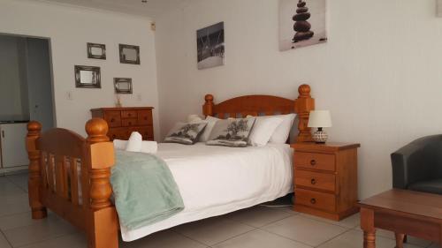 a bedroom with a bed and a desk and a chair at 8 Ibis Lane Guest House in Johannesburg